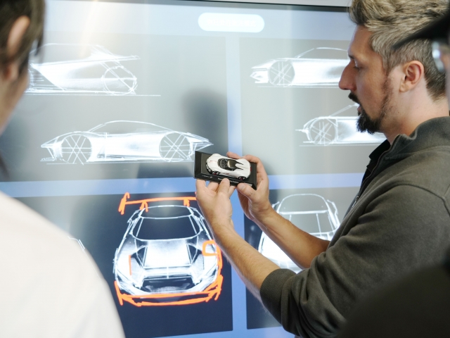 team-discussing-with-model-car-about-design