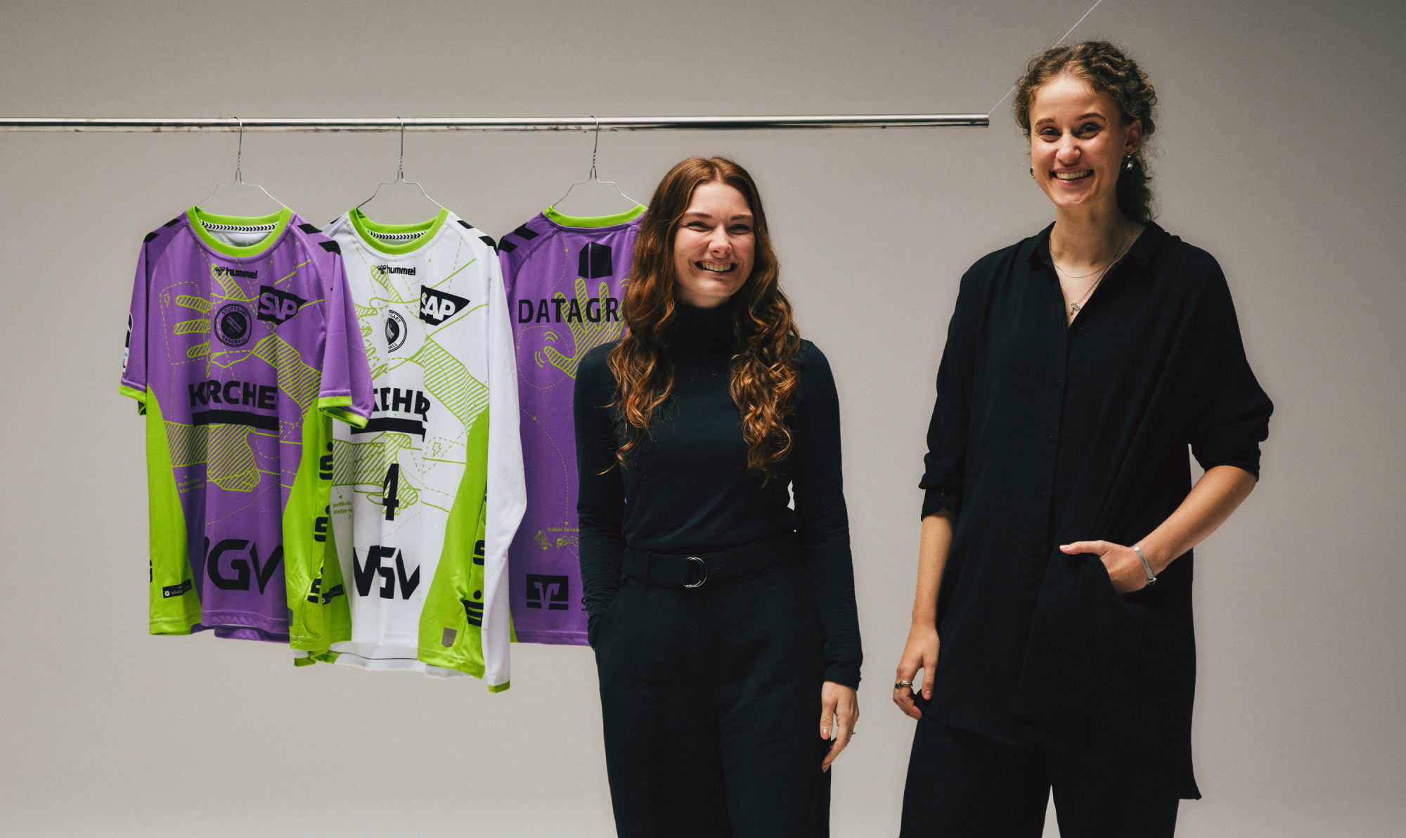 three-jersey-at-the-left-two-are-purple-one-white-and-two-women-dressed-black-proud