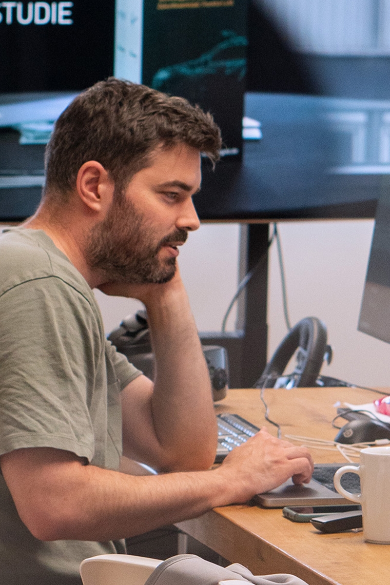 a-man-sits-in-front-of-a-large-screen-at-the-computer-and-talks