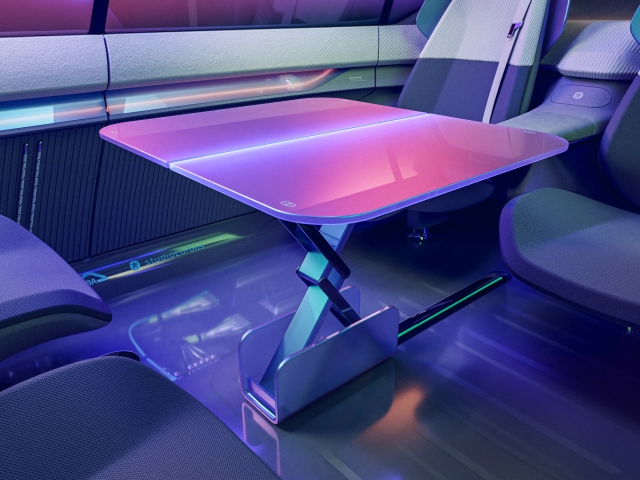rear-seats-facing-each-other-retractable-table-in-the-middle-interior-design-very-holistic-and-purple