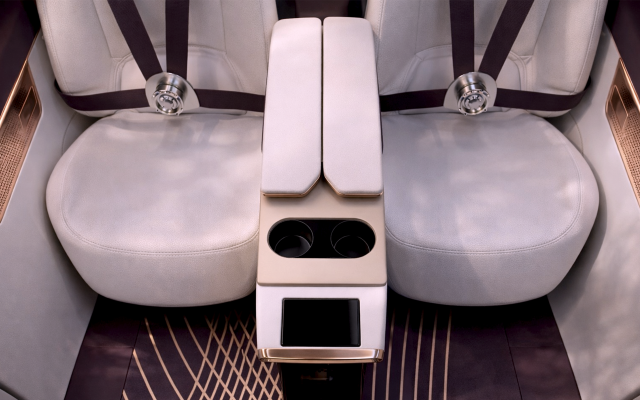 two-seats-covered-in-beige-nappa-leather-with-purple-seatbelts-and-golden-details-with-center-armrest-including-drink-holder-in-the-same-color-scheme