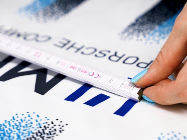 detail-photo-of-female-hand-with-light-blue-nails-holding-scale-against-dark-blue-logo-stuttgarter-kickers-jersey