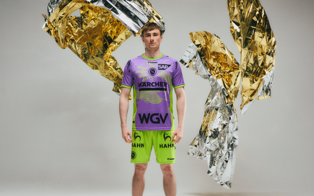 male-player-from-tvb-stuttgart-wearing-purple-green-jersey-with-topic-first-aid-arround-him-fire-blankets