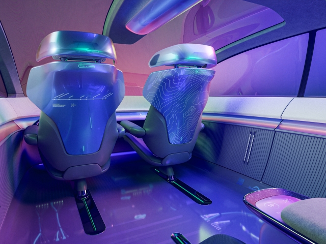 side-view-of-front-seats-from-behind-with-glass-roof-and-graphic-elements