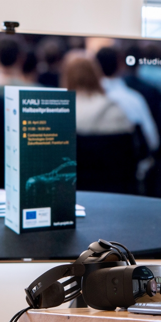 a-picture-of-a-large-screen-with-the-word-user-study-in-front-of-it-a-car-seat-with-VR-glasses-on-the-table