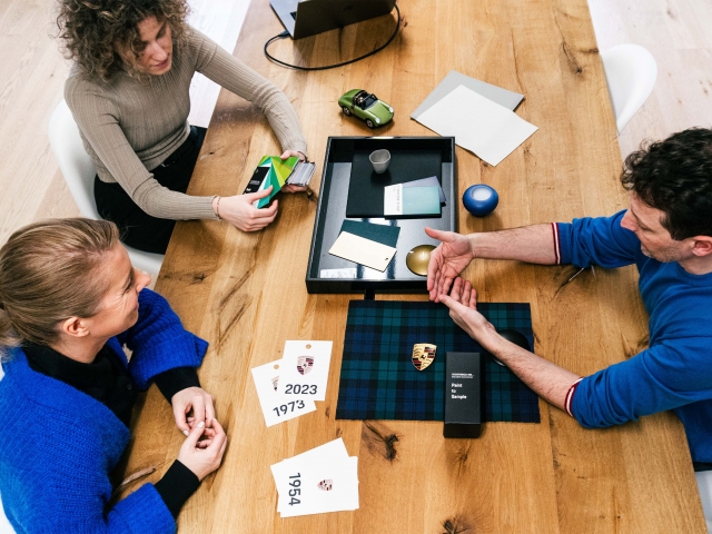 Meeting-room-two-women-and-one-man-are-talking-and-at-the-table-are-materials