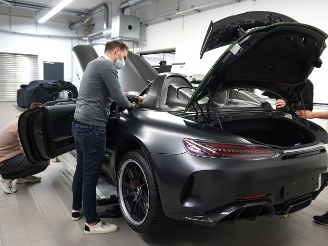 Grey-model-car-jacked-up-in-a-workshop
