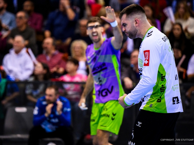 Goal-keeper-proud-and-euphorical-at-sustainbility-game-day-in-white-jersey-background-viewers-blurred