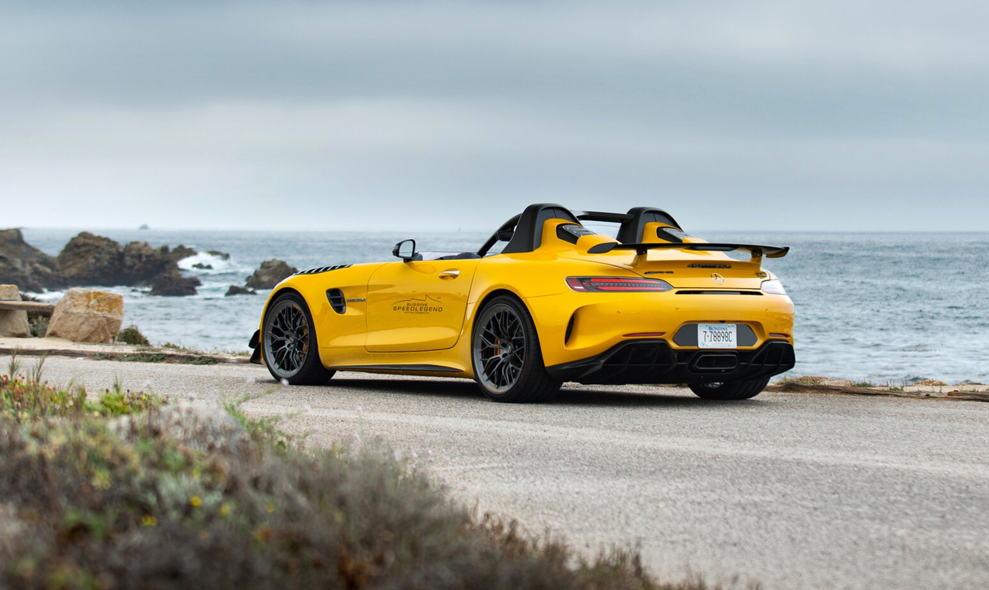 Photo-of-yellow-car-with-focus-on-exterior-and-sea-in-the-background