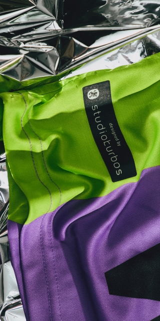 detail-picture-from-purple-sustainability-jersey-with-green-details-and-batch-with-lettering-designed-by-studiokurbos